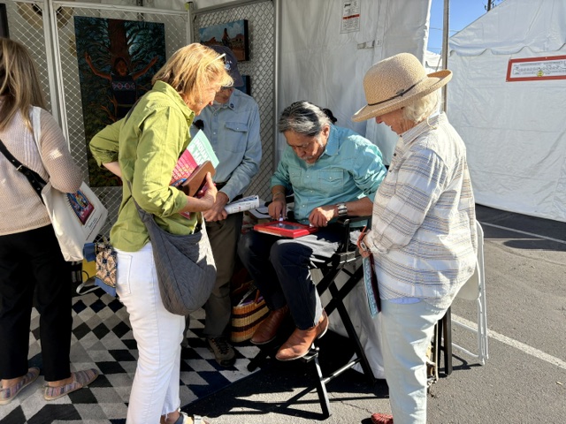 Shonto Begay drawing on an Etch A Sketch at the Heard Museum Indian Fair.